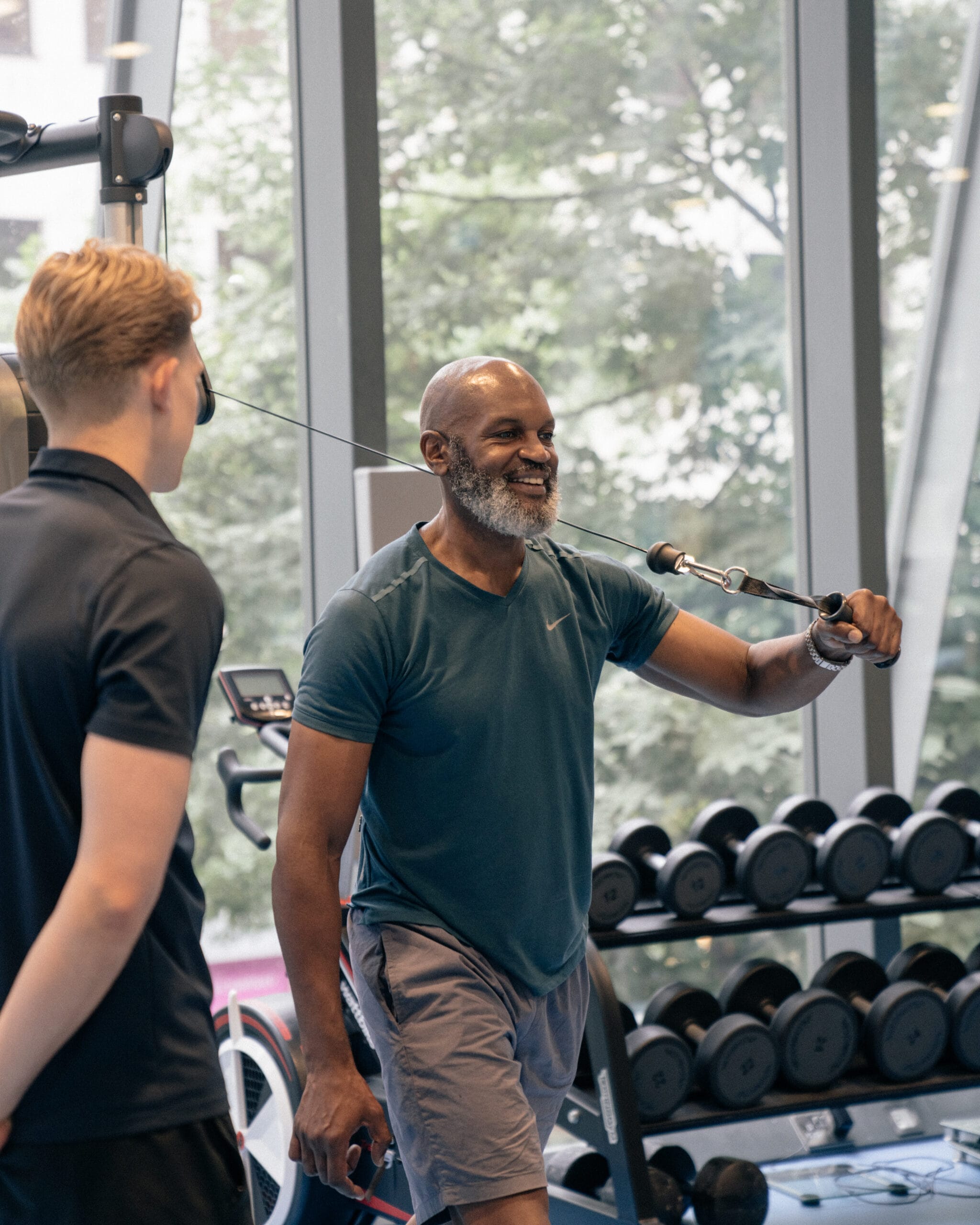 Clinician watching patient in strength and conditioning exercise
