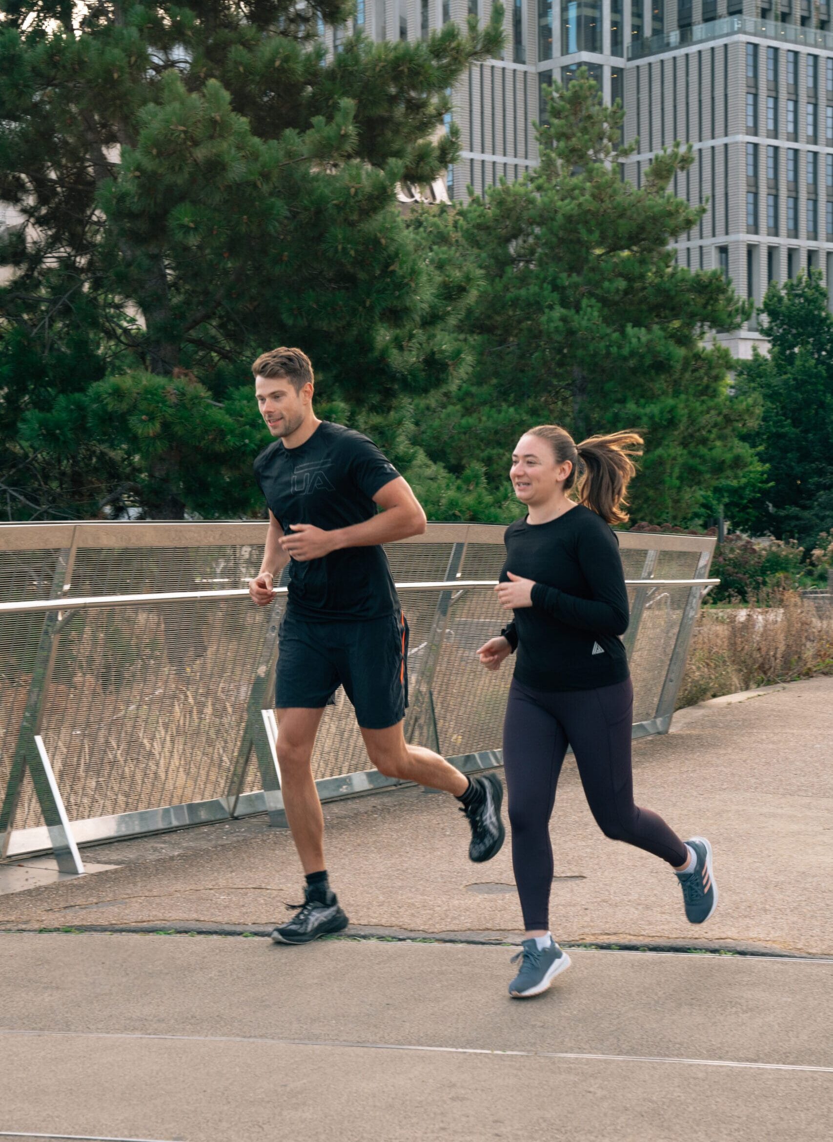 two people running on a bridge