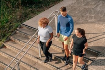 three people walking downstairs outside