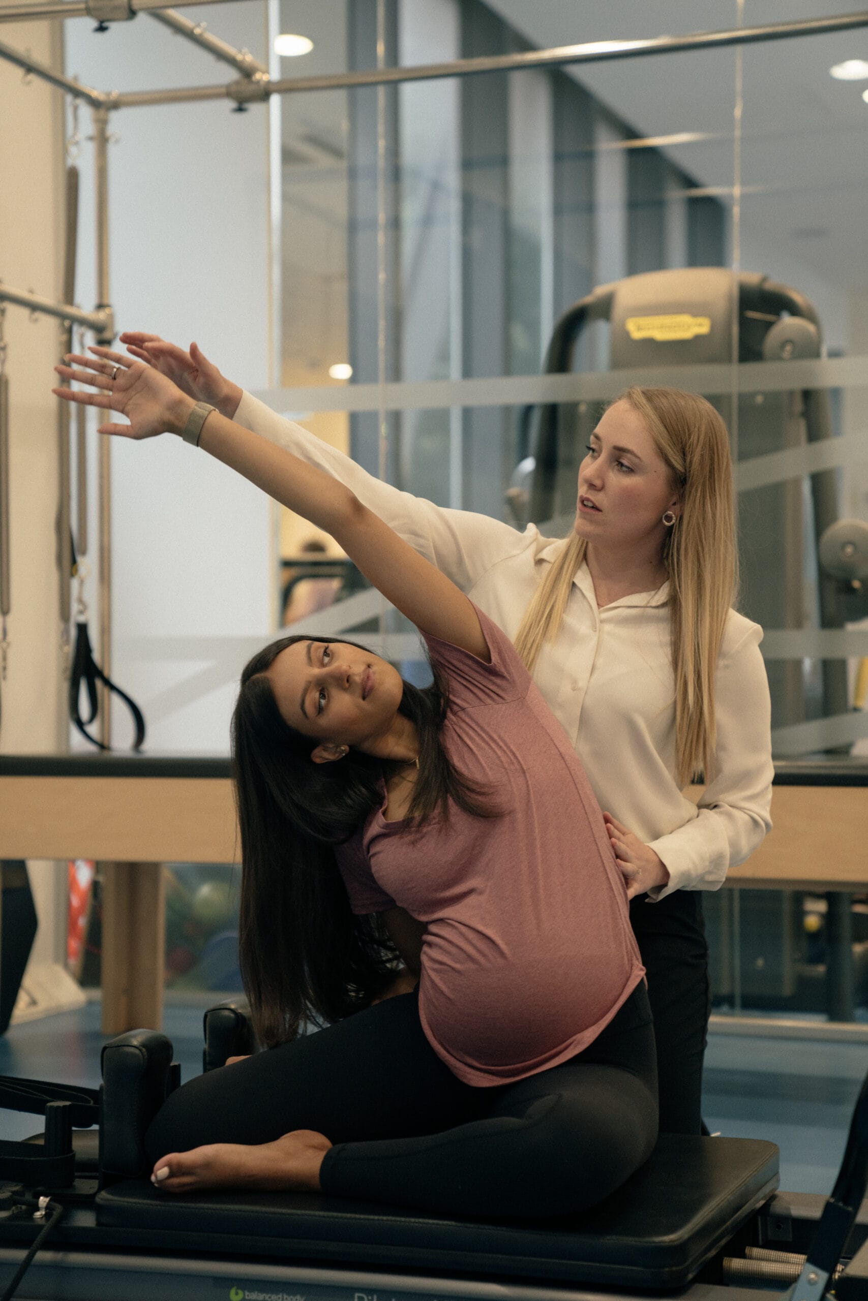 pregnant woman with clinician yoga
