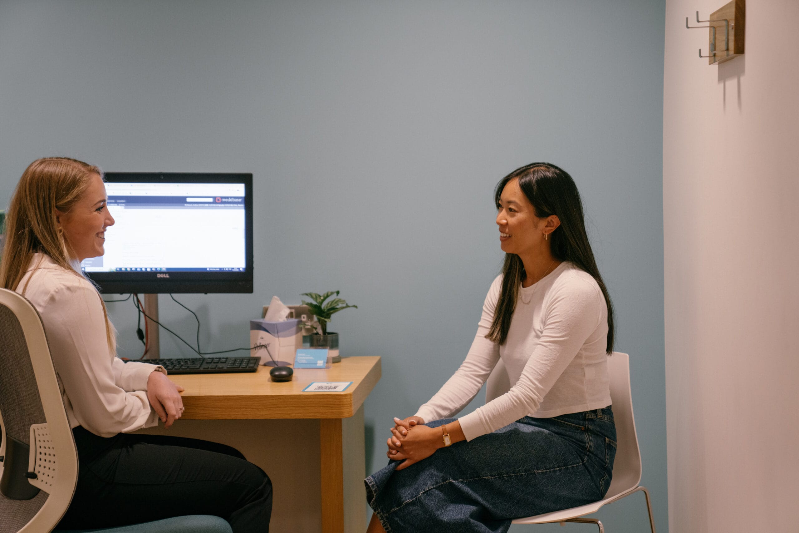 Patient talking to clinician in appointment room