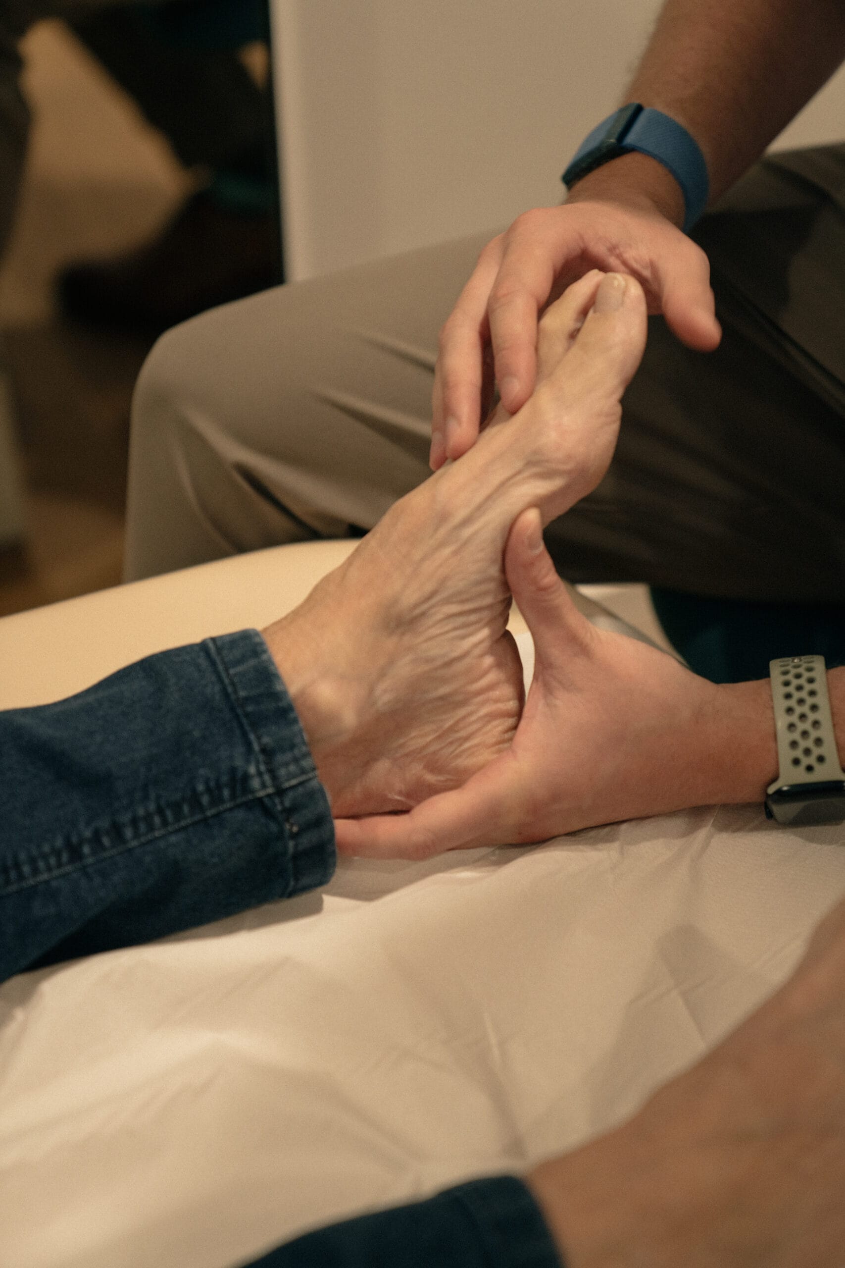 Close up of clinician bending patient's foot in assessment