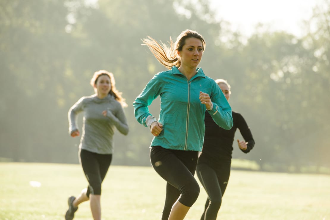 three people running outside