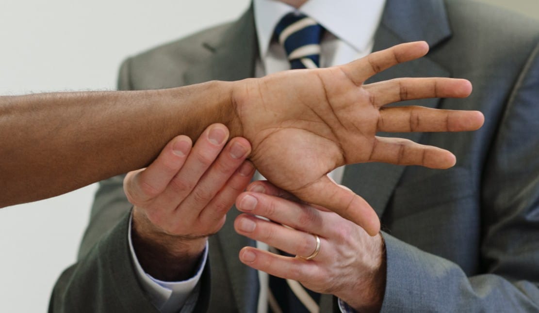 Clinician assessing patient's hand and wrist