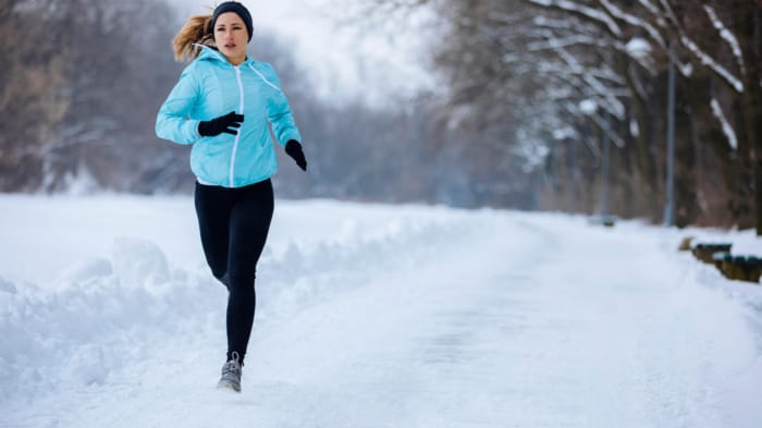 Woman running in snow