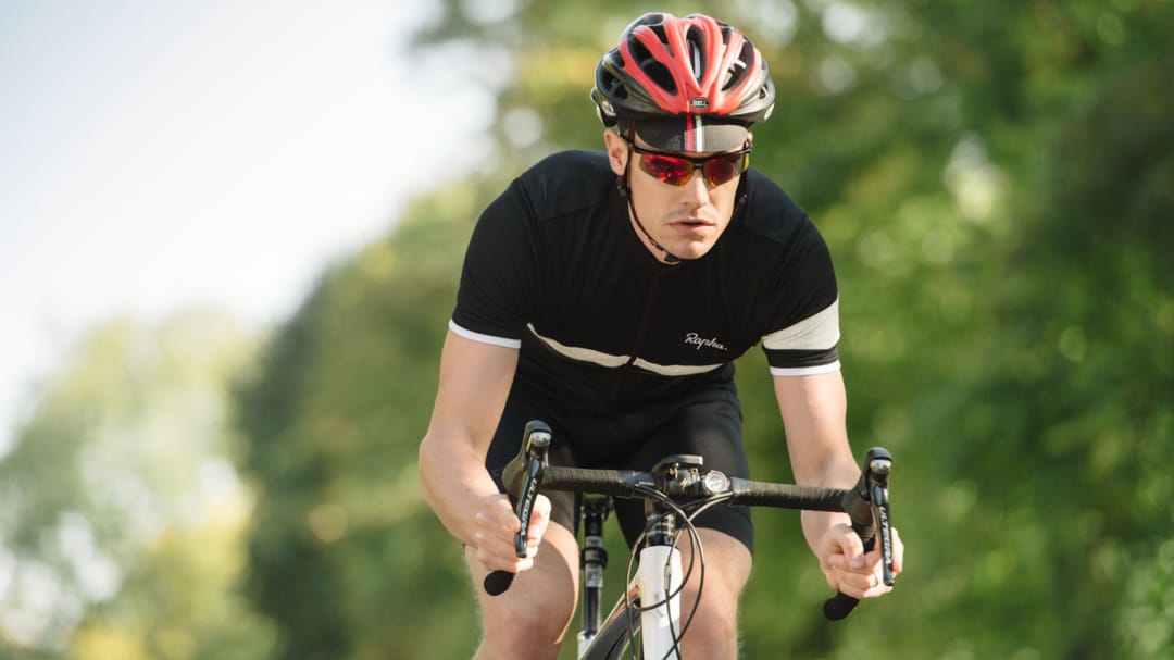 man riding a bike outside with helmet