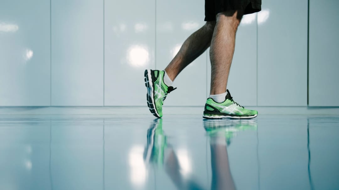 Two feet with green trainers