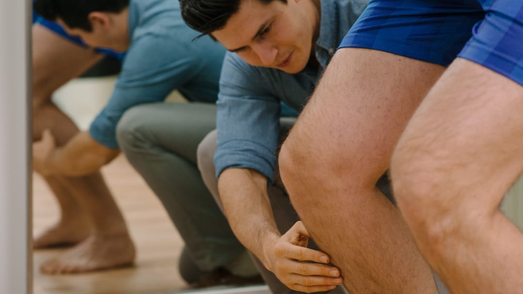 clinician assessing patient knee close up